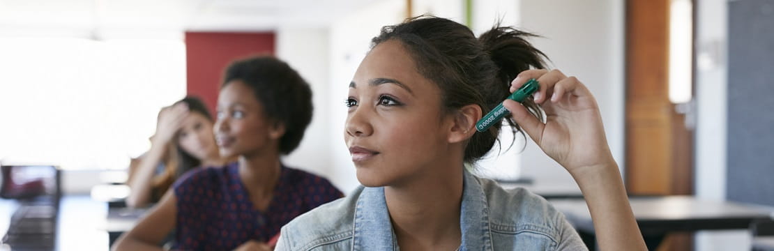 A female student seated at a classroom desk